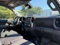 Interior view of a 2022 GMC Sierra 1500 showing the front seats dashboard and infotainment system