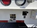Close-up of controls and lights on a 2008 International 7500 truck showing toggle switches and illuminated red lights