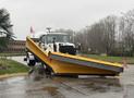 A 2016 Freightliner 108SD truck equipped with a large yellow snow plow attachment in the foreground