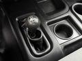 Close-up of the gear shift of a 2013 RAM 3500 with a black leather cover and a round shift knob indicating different drive modes