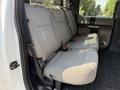 Interior view of a 2020 Ford F-350 SD showing the backseat area with gray fabric upholstery and seat belts
