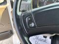 A close-up of the steering wheel in a 2006 Sterling Acterra featuring an ON/OFF button on the left side