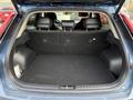 The image shows the spacious cargo area of a 2023 Kia Niro EV with the rear seats folded down and featuring a flat loading floor