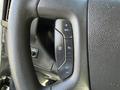Close-up of a steering wheel control panel featuring buttons for cruise control settings such as resume, set, and adjustments in a 2017 Chevrolet Express