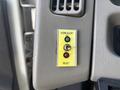 A control panel with a yellow switch labeled 'HORN ALERT' featuring a green light above and a red light below along with a black 'RESET' button