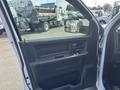 A 2012 RAM 2500 truck door interior featuring a window control panel and door handle
