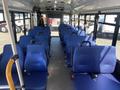 Interior view of a 2020 Chevrolet Express with blue seating arranged in rows and a wide aisle down the center