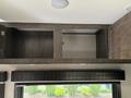 A closed overhead storage cabinet with two compartments in a 2021 Jayco Jay Flight RV