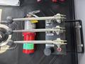 Control levers for a 2014 Freightliner M2 106 with three metal handles labeled fronts rears and sides along with a red fire extinguisher mounted nearby
