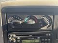 Dashboard controls of a 2008 International 4400 featuring climate control knobs and a radio display showing the time and station