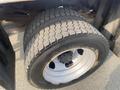 A close-up view of a large tire on a 2016 RAM 5500 showcasing its rugged tread pattern and metallic rim