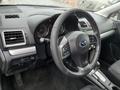 Interior view of a 2016 Subaru Forester showing the steering wheel dashboard and controls
