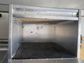 A 2008 Wells Industries Inc EW1422 equipment unit with a metal exterior and a sliding top, featuring a textured floor surface and smooth walls