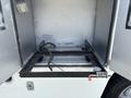 2011 Workhorse W62 with an empty cargo area featuring a metal frame and a hose lying on the floor