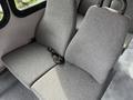 Two gray upholstered seats with headrests are visible in the interior of a 2014 Ford Econoline van