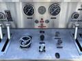 Control panel of a 1994 Volvo FE 42 featuring gauges switches and a steering wheel with various buttons and levers for vehicle operation