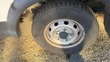 A close-up view of a wheel on a 2021 Ford Transit showing the rim and tire details