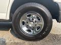 Close-up of a chrome wheel rim with five circular openings featuring the Chevrolet logo on a 2021 Chevrolet Express tire