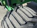 A close-up view of the tire of a 2015 JLG 450AJ with a rugged tread pattern showing wear and texture