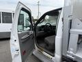 A 2004 Ford F-350 SD with the driver's door open revealing a gray interior and dashboard