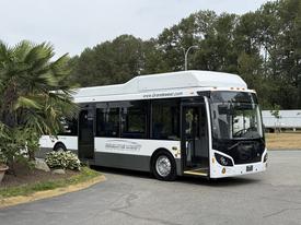 A 2018 Grande West Vicinity bus in white and black with a sleek design and open doors inviting passengers inside