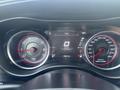 The dashboard of a 2015 Dodge Charger displaying speedometer and tachometer with red accents and digital screen indicating speed and temperature
