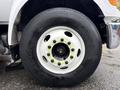 Close-up of a 2011 Ford F-650 wheel featuring a white rim and a black Hankook tire with prominent lug nuts
