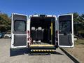A 2020 RAM ProMaster 3500 with its rear doors open revealing seats and interior space designed for passenger transport