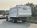 A white 2009 Ford F-550 with a dump truck bed and the words HAU-ALL on the back