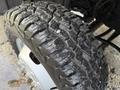 Close-up of a rugged tire on a 2018 Ford F-350 showing deep treads and a metallic wheel hub