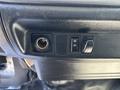 Close-up of the dashboard controls of a 2020 Hino 338 featuring a power outlet switch a defrost switch and an air conditioning knob