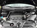 The image shows the engine bay of a 2014 Honda Odyssey with visible components including the engine block battery and various hoses and fluids