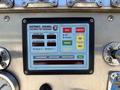 Control panel of a 2004 American LaFrance Eagle fire truck featuring buttons for engine RPM, volts, oil pressure, and an information center display