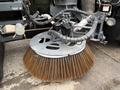 A 2009 UD Trucks UD 3300 featuring a large circular brush attachment with thick bristles designed for street sweeping or cleaning surfaces