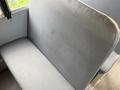 A gray upholstered bench seat with a smooth texture and a slight curve along the top edge