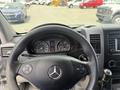 Interior view of a 2016 Mercedes-Benz Sprinter with a steering wheel and dashboard displaying gauges and controls