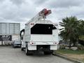 A white 2021 Freightliner M2 106 bucket truck with a raised aerial lift mounted on top and an open rear compartment