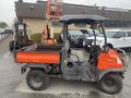 A 2010 Kubota RTV 900 utility vehicle with an orange cargo bed and a gray cabin visible from the side