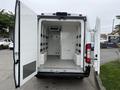 The image shows the open rear doors of a 2020 RAM Promaster revealing a spacious cargo area with a clean white interior and no visible shelving or cargo