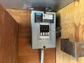 A Siemens electrical panel mounted on a wooden surface displaying multiple circuit breakers and labels