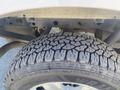 Close-up of the rugged tire of a 2017 Ford F-150 showcasing its deep treads and brand markings