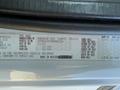 A 2011 Freightliner M2 106 vehicle identification label with specifications including vehicle type, manufacturer, and weight details
