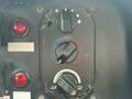 Close-up of control knobs on a dashboard featuring a red and blue temperature dial and a black switch for various settings
