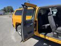 A 2013 Chevrolet Silverado 1500 with a partially open door revealing a spacious interior and seating area