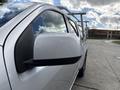 A 2018 Chevrolet Colorado is shown from the side focusing on the side mirror with a chrome finish and black detailing