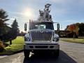 A 2011 International 7500 truck with a bucket lift on top facing the viewer