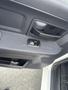A close-up of the interior door handle and window control panel of a 2012 RAM 2500