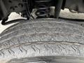 Close-up of a tire from a 2023 Ford F-450 Super Duty showing detailed tread pattern and texture