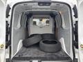 A 2019 Ford Transit Connect van interior filled with four black tires resting on the floor