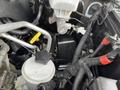 2015 RAM 2500 engine compartment with various components including a black battery, fluid reservoir, and several cables and hoses